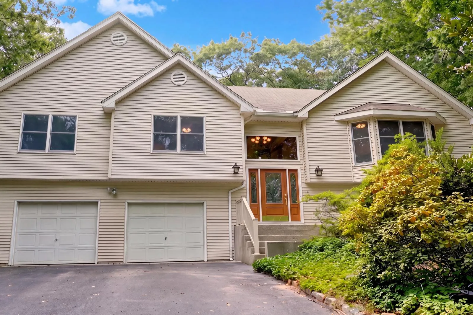 Front exterior of a colonial on a wooded lot, real estate photography, Suffolk County