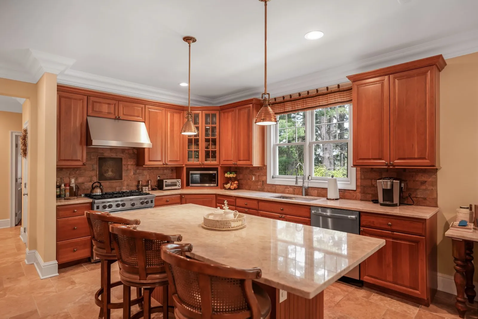 Cherry kitchen with island seating and a brick backsplash, real estate interior photography, Nassau County