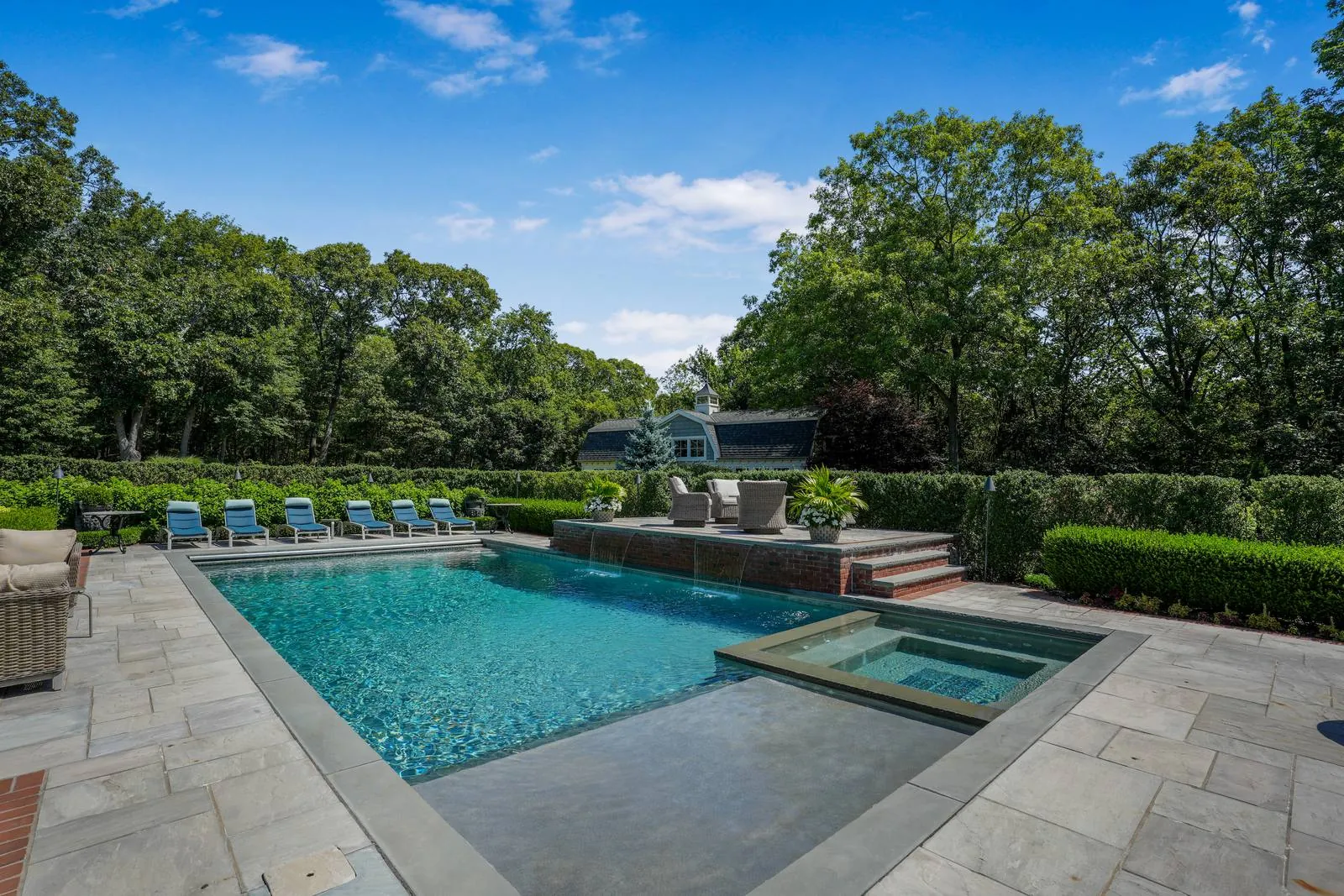 Gunite pool and bluestone patio with a spa, real estate exterior photography, Suffolk County